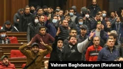 Protesters storm the parliamentary assembly in Yerevan on November 10 after Armenian Prime Minister Nikol Pashinian said he had signed an agreement with the leaders of Russia and Azerbaijan to end the war in Nagorno-Karabakh. 