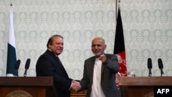Pakistani Prime Minster Nawaz Sharif (L) shakes hands with Afghan President Ashraf Ghani during a press conference at the Presidential palace in Kabul on May 12.