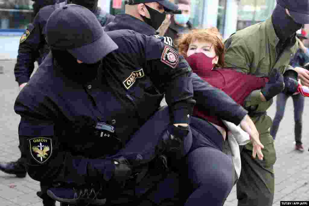 Belarus - Anti-riot police officers detain and arrest a woman demonstrating during a rally to protest against the presidential election results in Minsk, 19sep2020