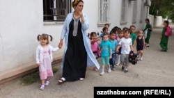 Çagalar bagynyň terbiýeçisi we körpeler. Arhiwden alnan surat