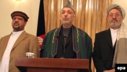 President Hamid Karzai (center) with his vice presidents, Mohammad Qasim Fahim (left) and Karim Khalili, at a press conference in Kabul.