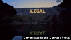 Asociația civică Declic a proiectat în mod repetat termenul „ilegal” pe barajul folosit ca ecran de proiecție.