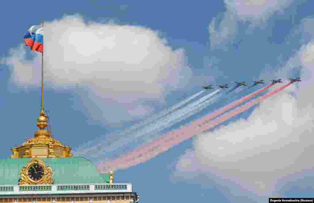 Russian Su-25 jets release smoke in the red, white, and blue colors of the Russian flag. At least 75 military aircraft took part in the Victory Day celebrations.&nbsp;